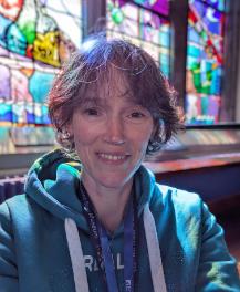 Sarah in front of a stained glass window
